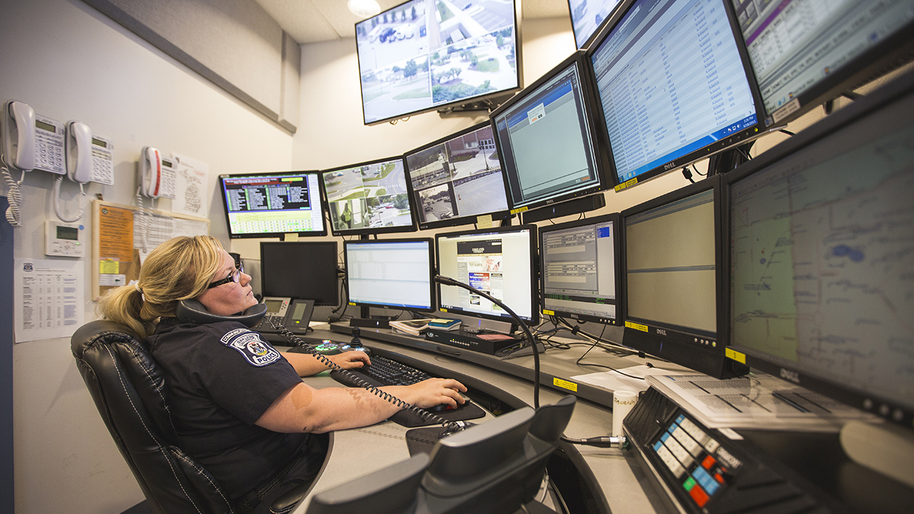 Security staff at work in front of computer screens