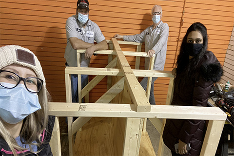 OU students and Jabil personnel work on rug racks at Humble Design