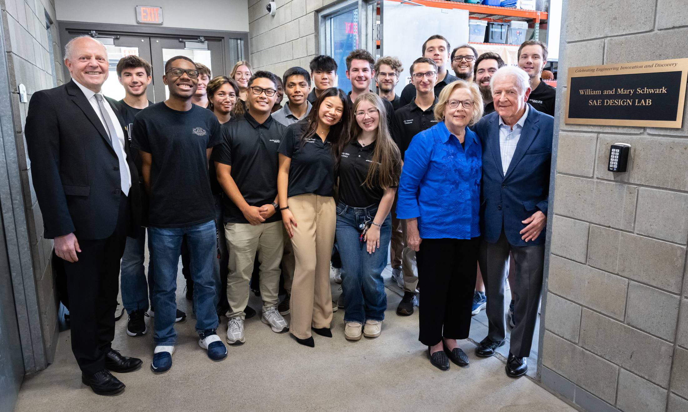 William and Mary Schwark outside the William and Mary Schwark SAE Design Lab with OU students and faculty