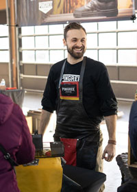 Man wearing an apron smiliing