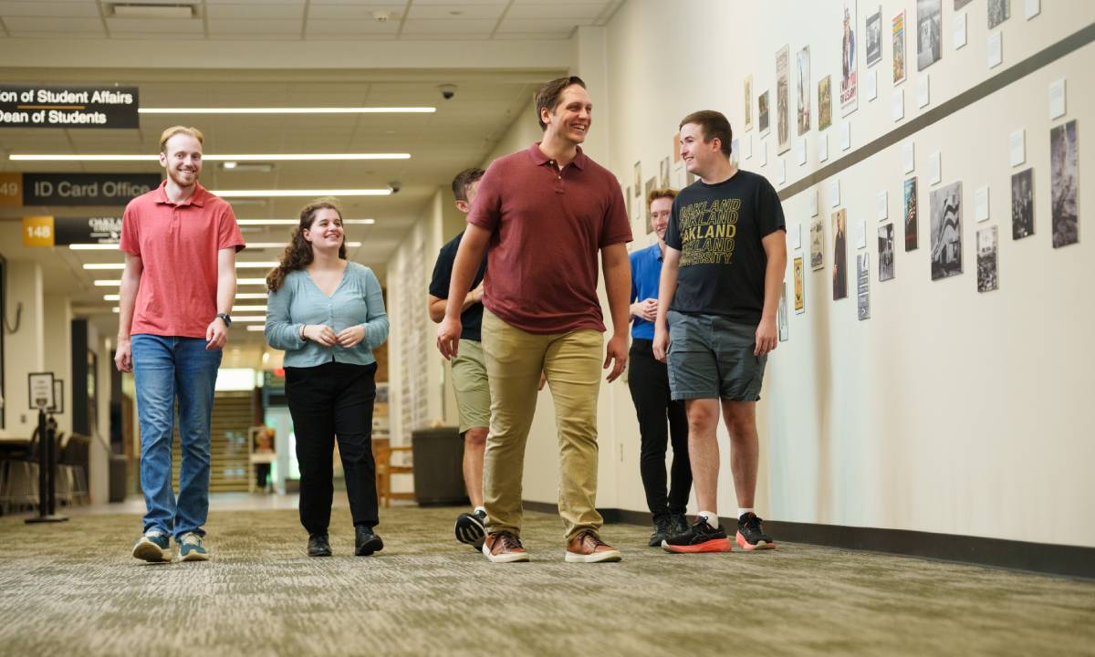 Students and professor next to history timeline