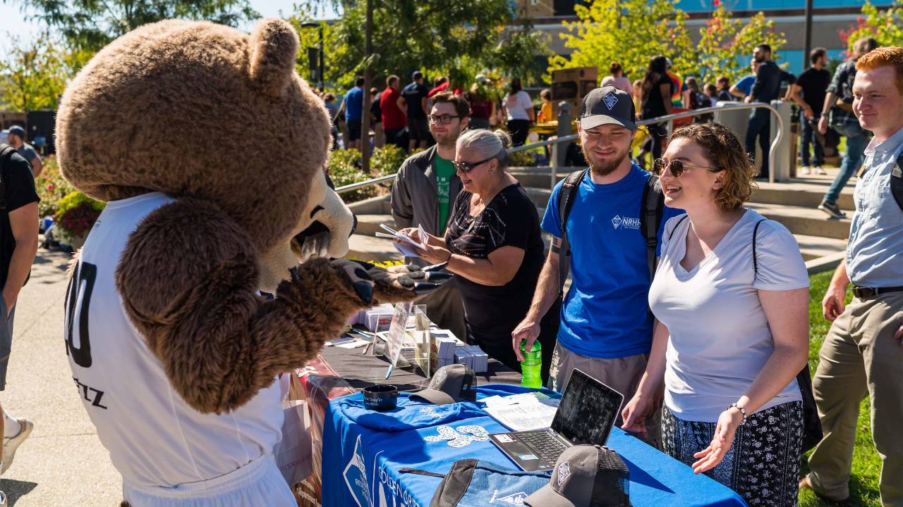 OU students outside during Welcome Week with Grizz