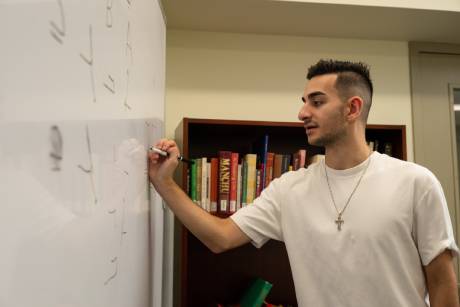 Student writing on whiteboard