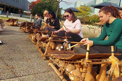 Young peoople playing african instruments.