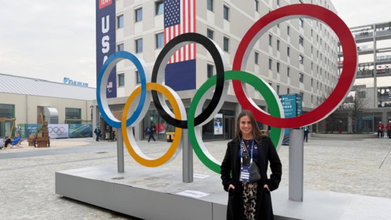 Renee Petkovski standing in front of Olympic rings