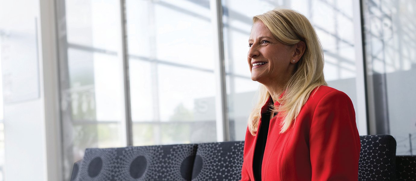 A woman inside, smiling.