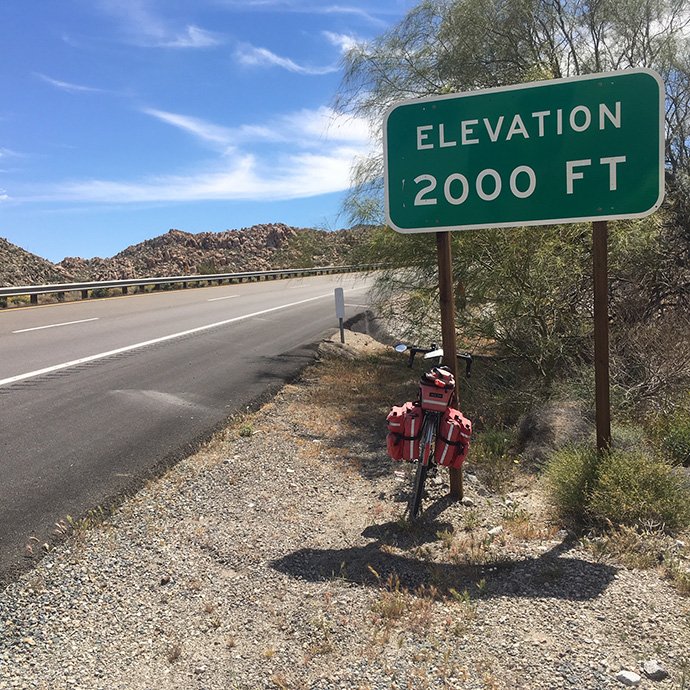 Road and bicycle with road sign that states 
