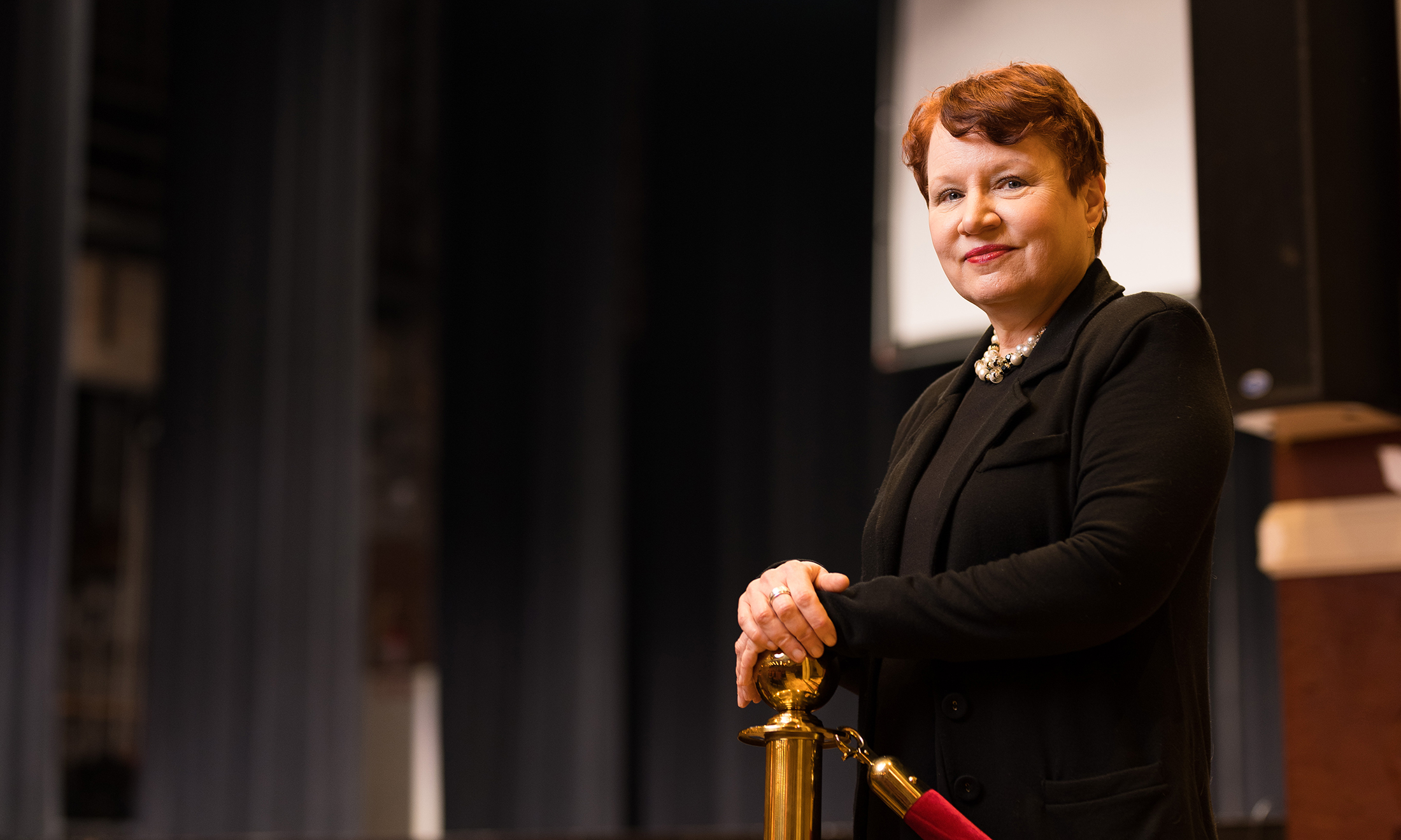 A woman standing in a theatre