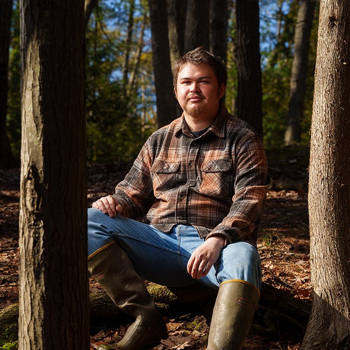 A person sitting between two trees