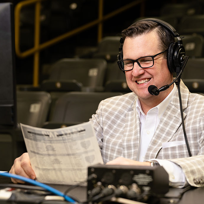 Man looking at score sheet at basketball game