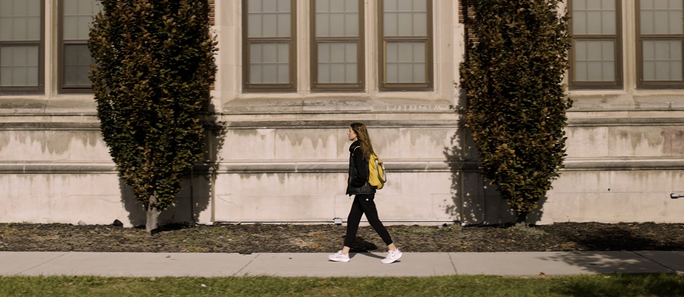 Woman walking on sidewalk