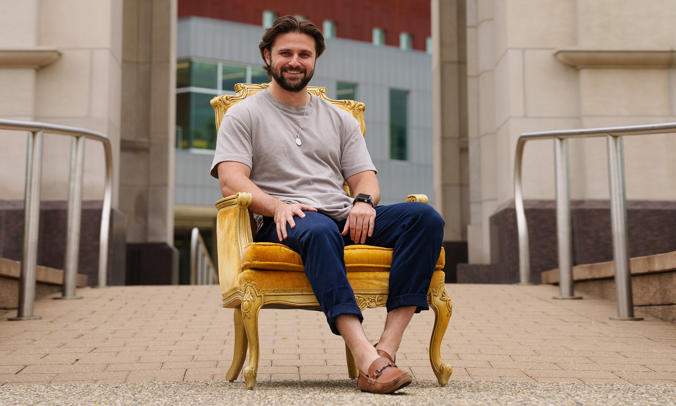 Man sitting in gold seat