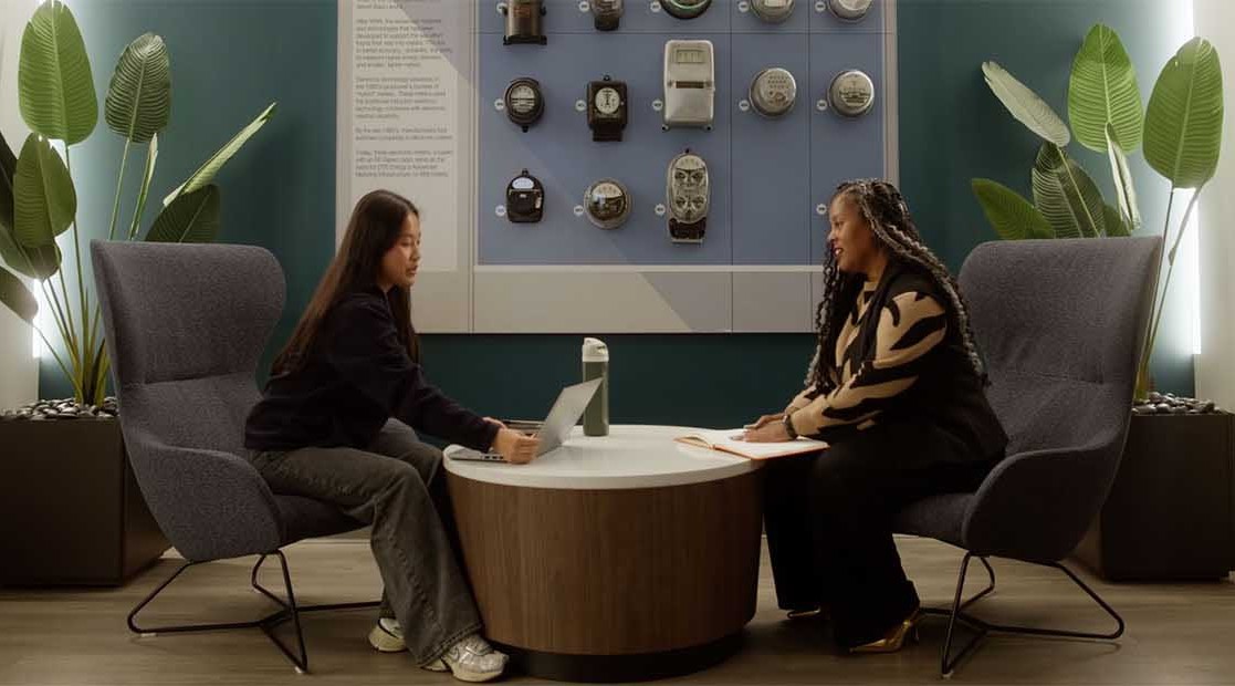 two people walking down a hallway