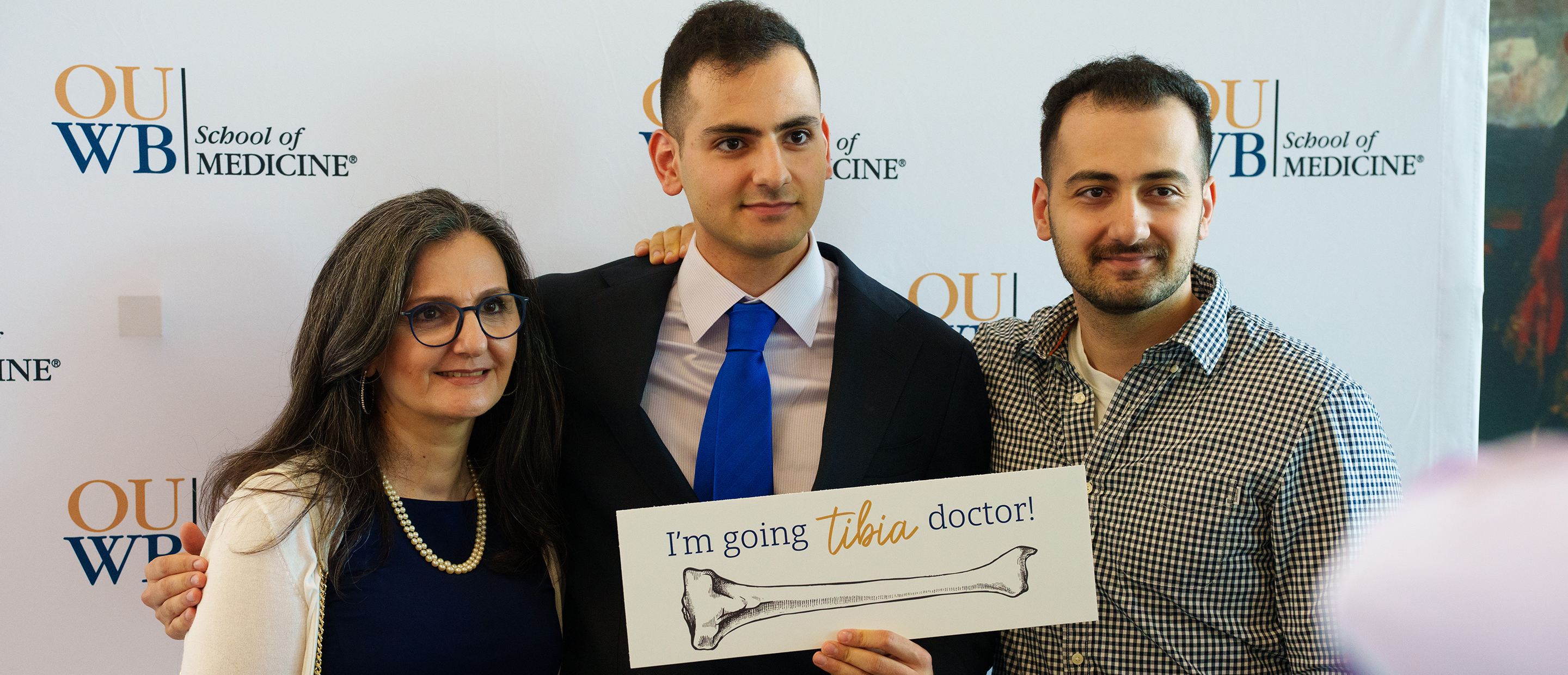 An image of a student and family at white coat