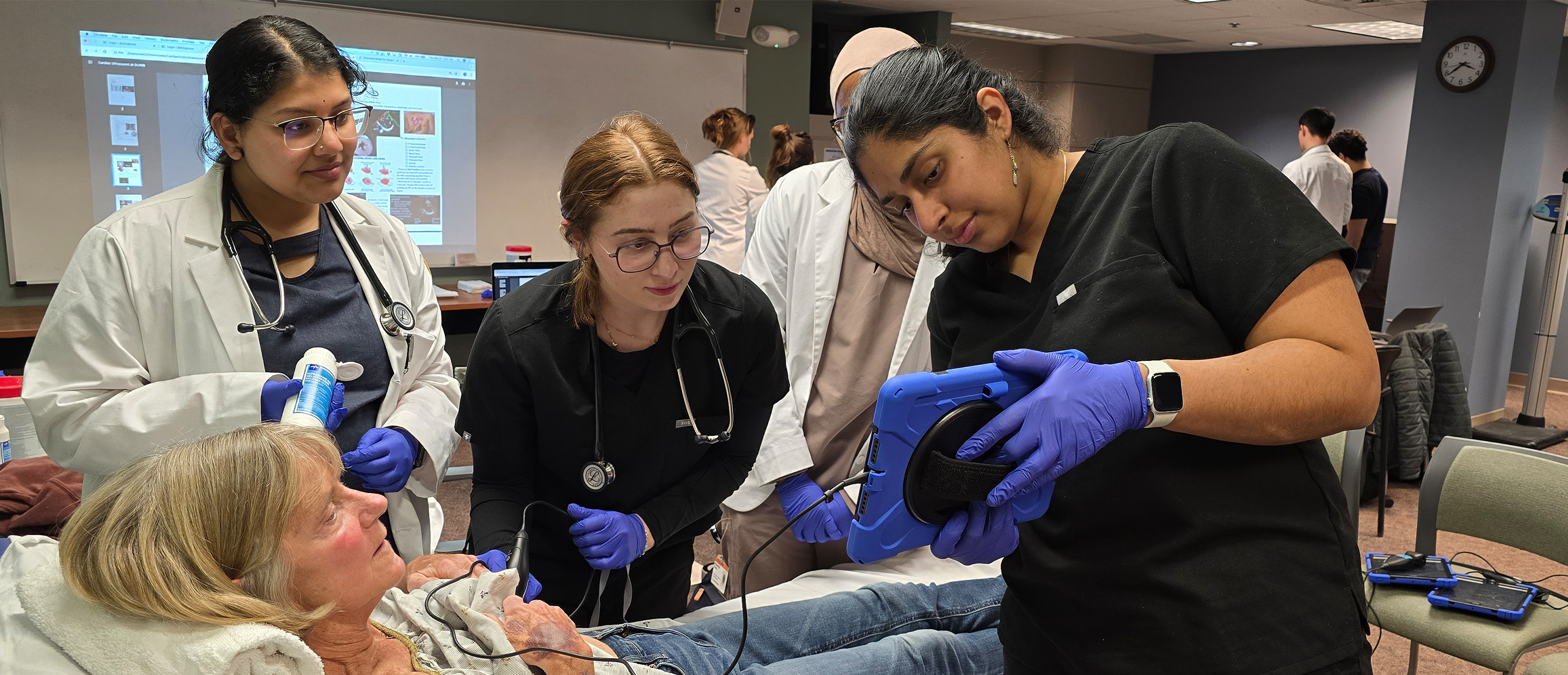 An image of students with a standardized patient