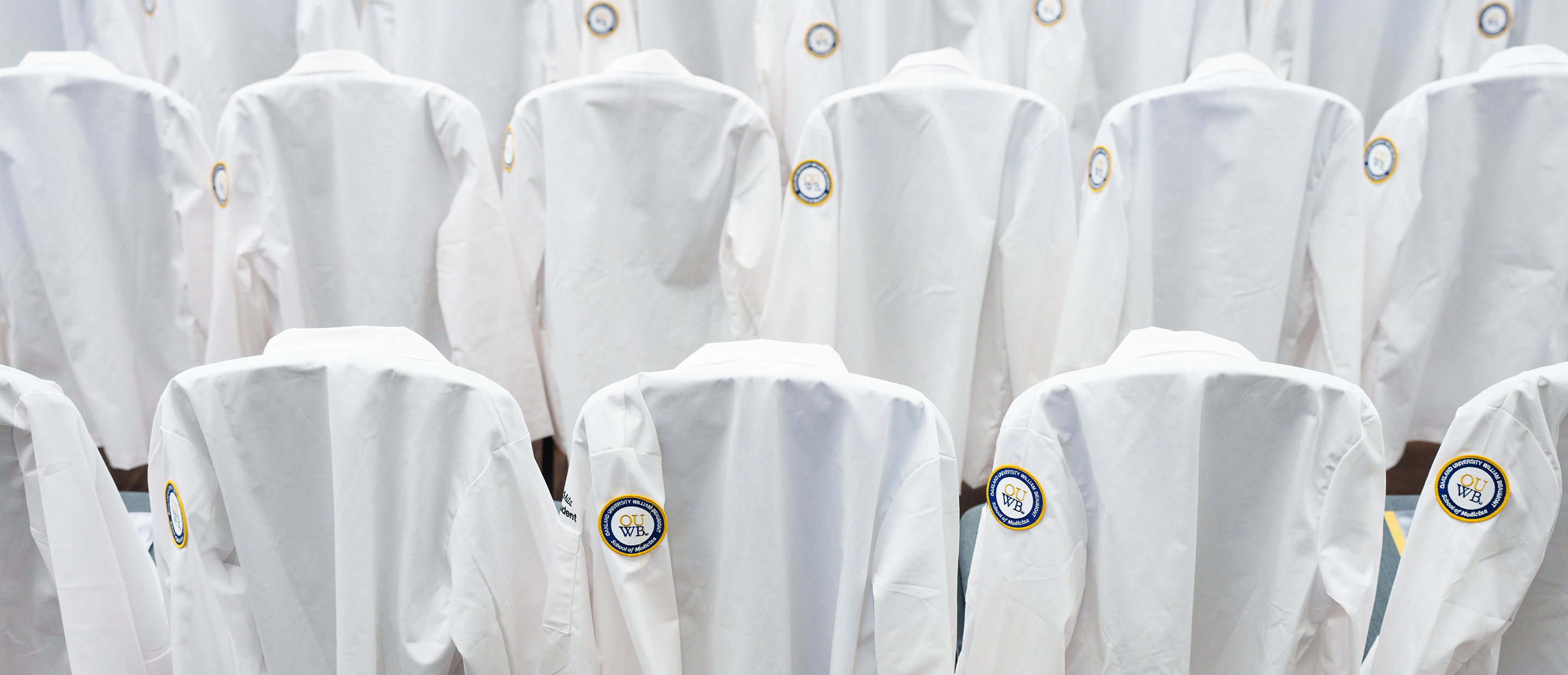 An image of white coats with the OUWB patch
