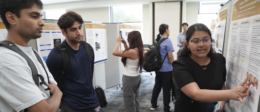 An image of a student presenting a poster