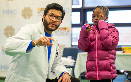 An image of a medical student and a patient