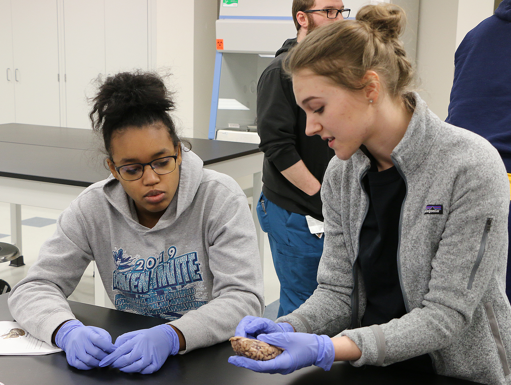 A medical student teaching a high school student