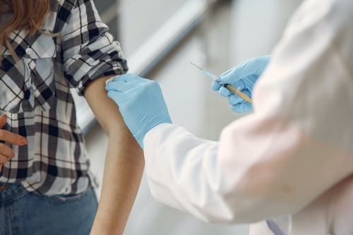 An image of a doctor administering a vaccine