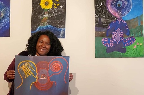 An image of a student showing her art