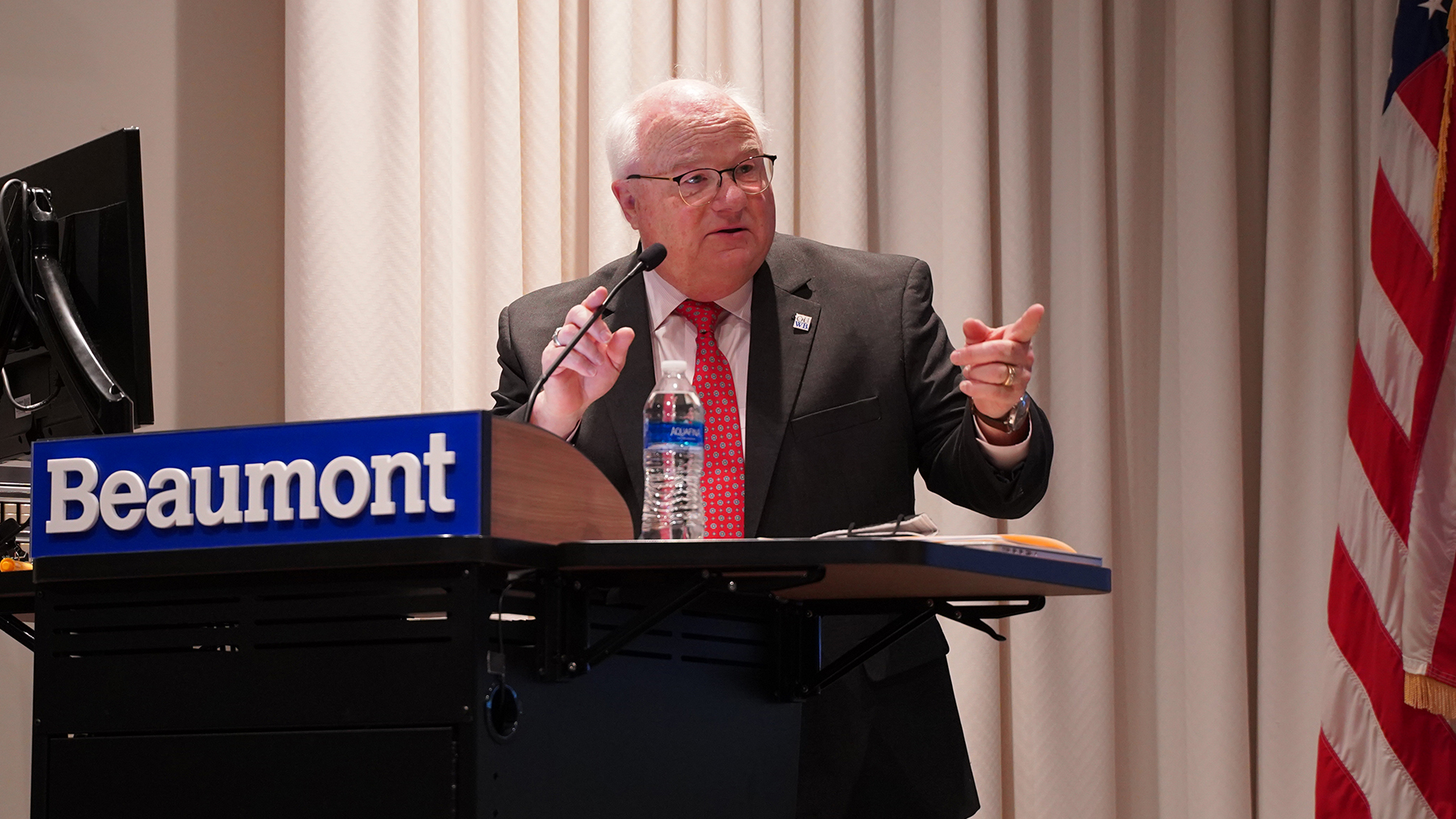 An image of Dr. Mezwa at a podium