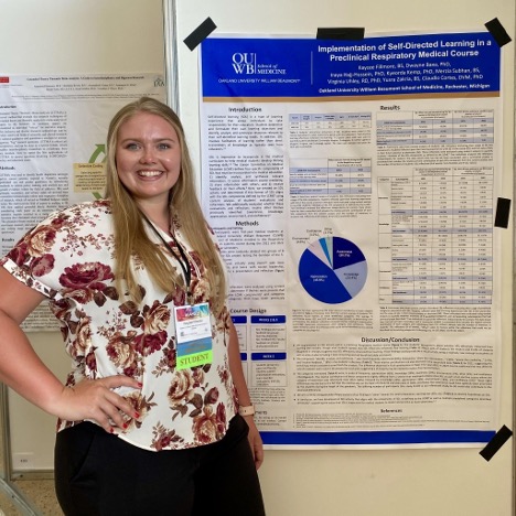 An image of Kaycee Fillmore next to her poster