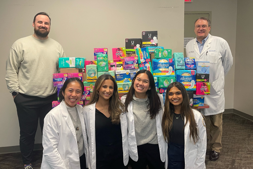 OUWB student in front of products collected