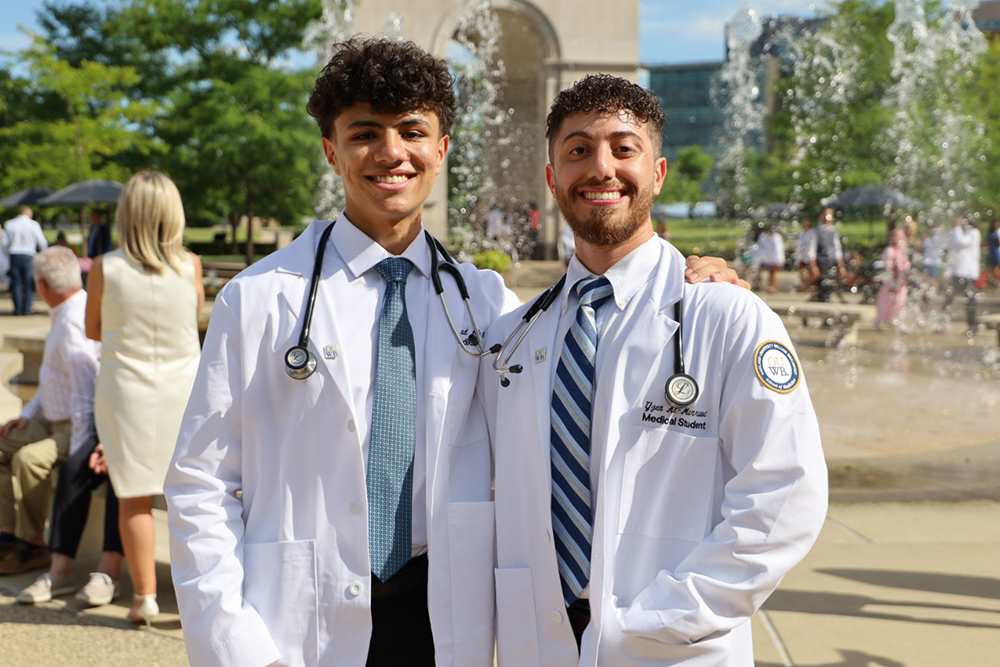 An image of two students in white coats