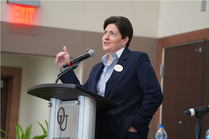 An image of Dr. Thompson at a podium