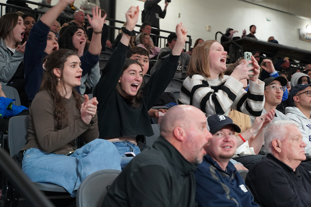 The crowd cheers at an OU men's basketball game