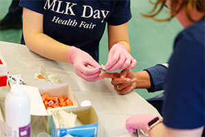 An OUWB student doing a health screening