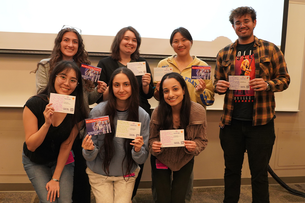 OUWB students holding postcards