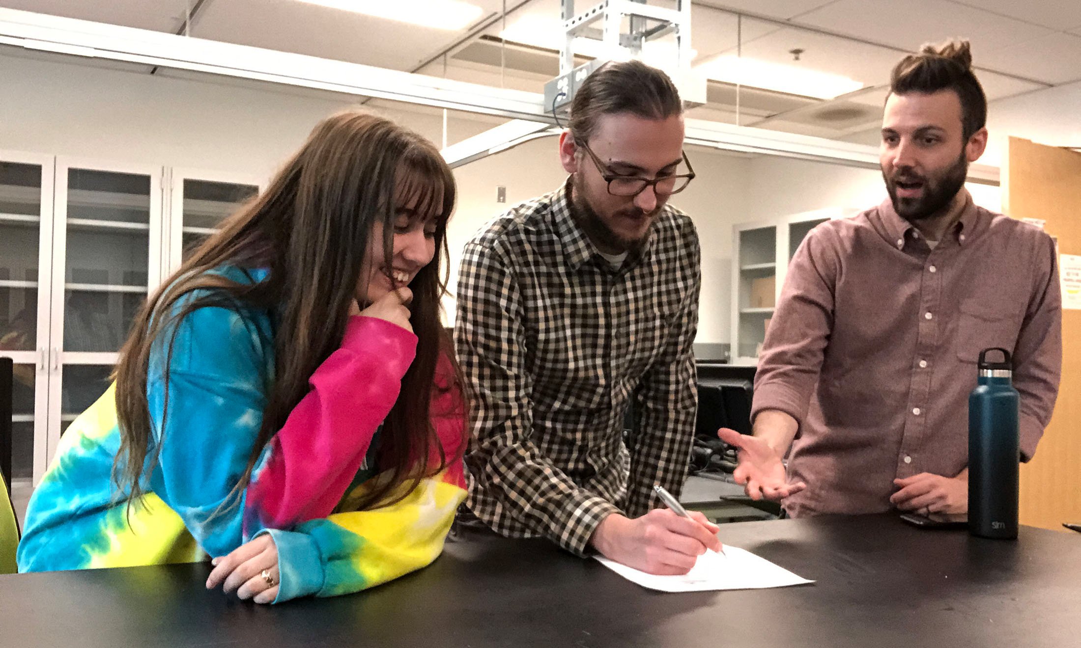 Three people working at a table