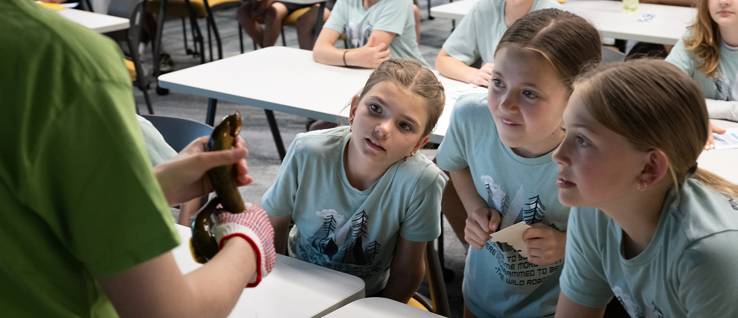 Children standing around teacher