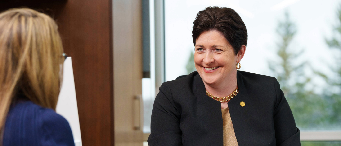 Dr. Thompson sitting at a desk.