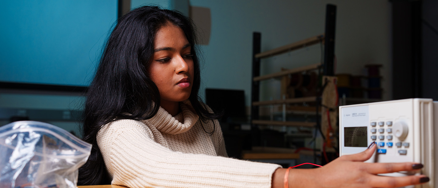 A woman working on an electrical panel