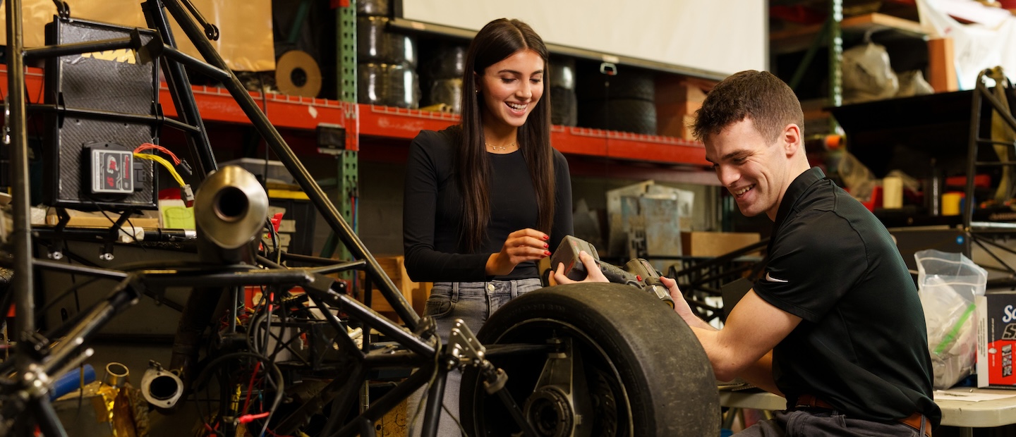 Two students working in a mechanical lab.