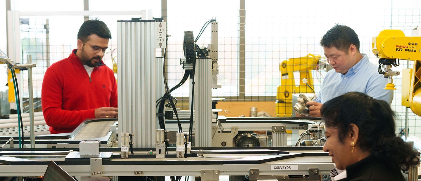 People working in an industrial/mechanical lab