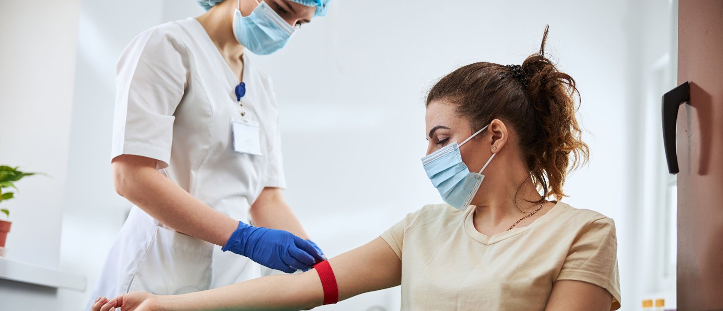 A medical professional drawing blood from a patient.