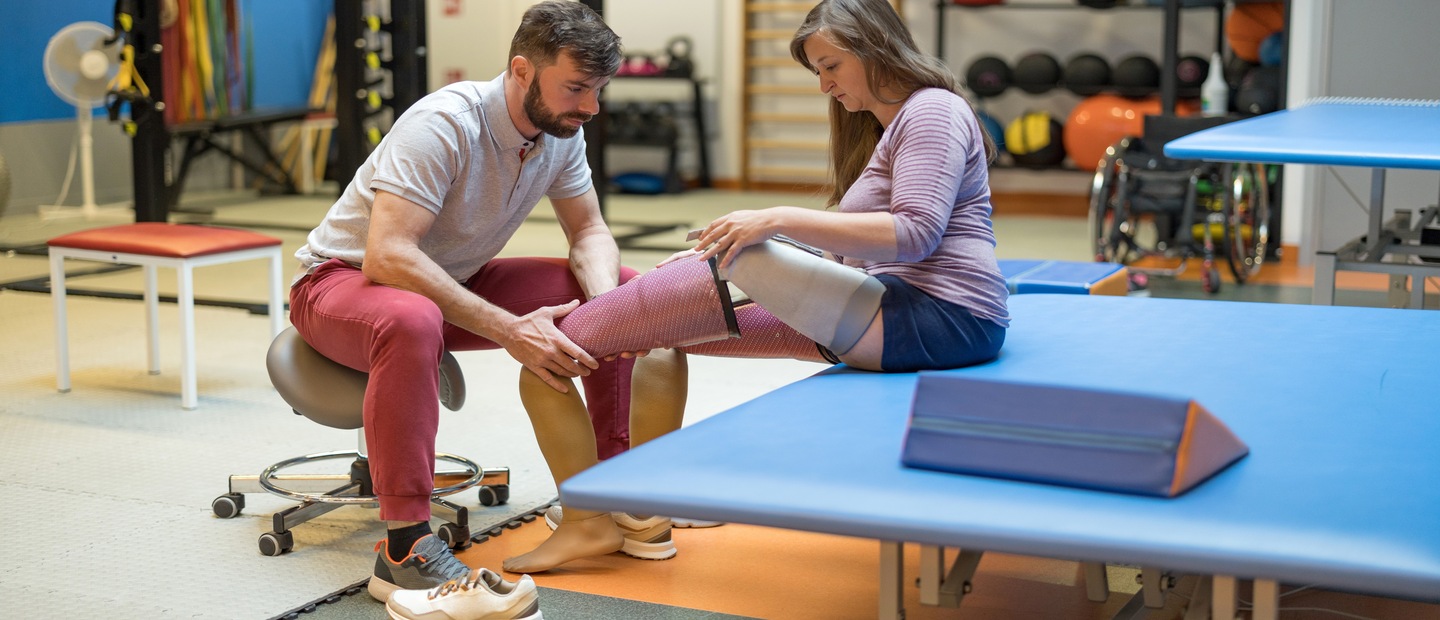 Prosthetic leg fitting A man fitting a woman with a prosthetic leg