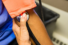 close-up image of a person taking another person's pulse