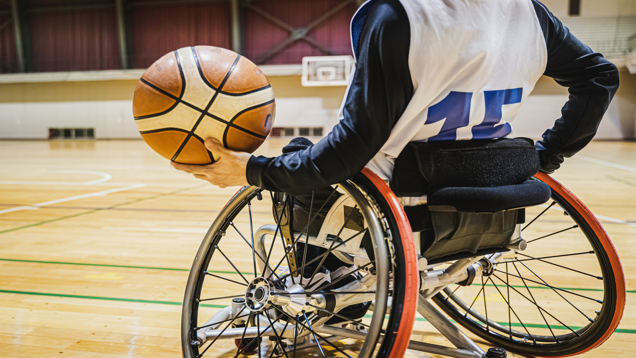 A person in a wheelchair playing basketball.