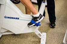 A person's foot pedaling an exercise bike.