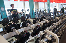 image of a weight room with a person lifting weights