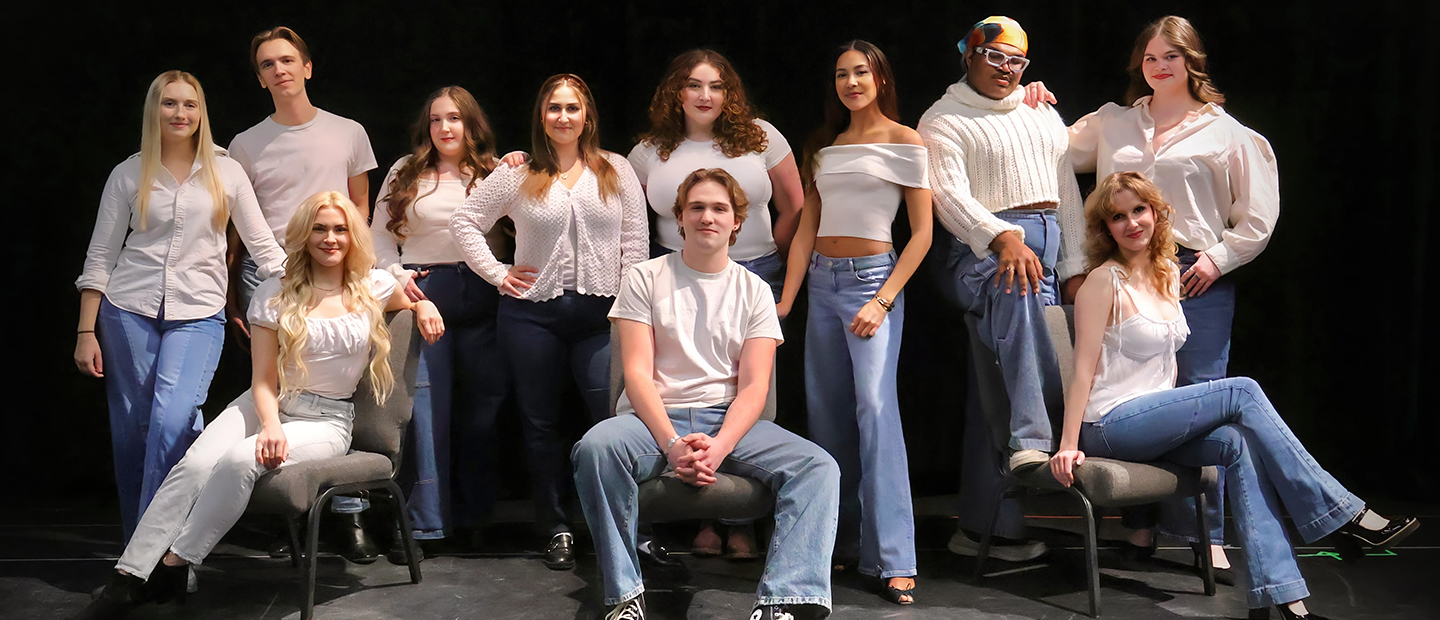 Actors on a stage prepare to take a bow