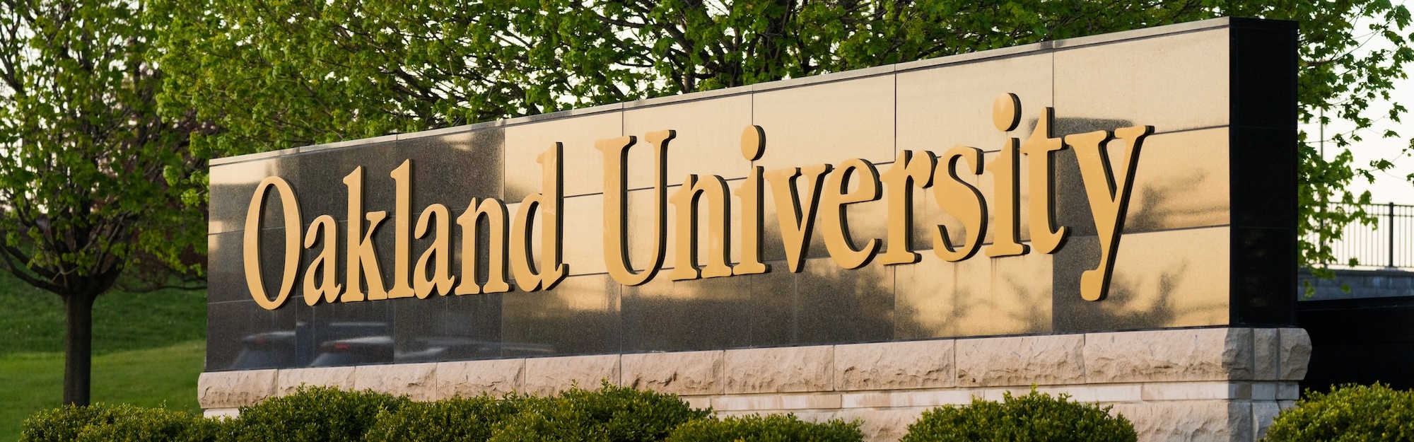 The Oakland University sign at the entrance to Oakland University's campus