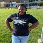 Dana Cogshell wearing a First Generation Oakland University button.