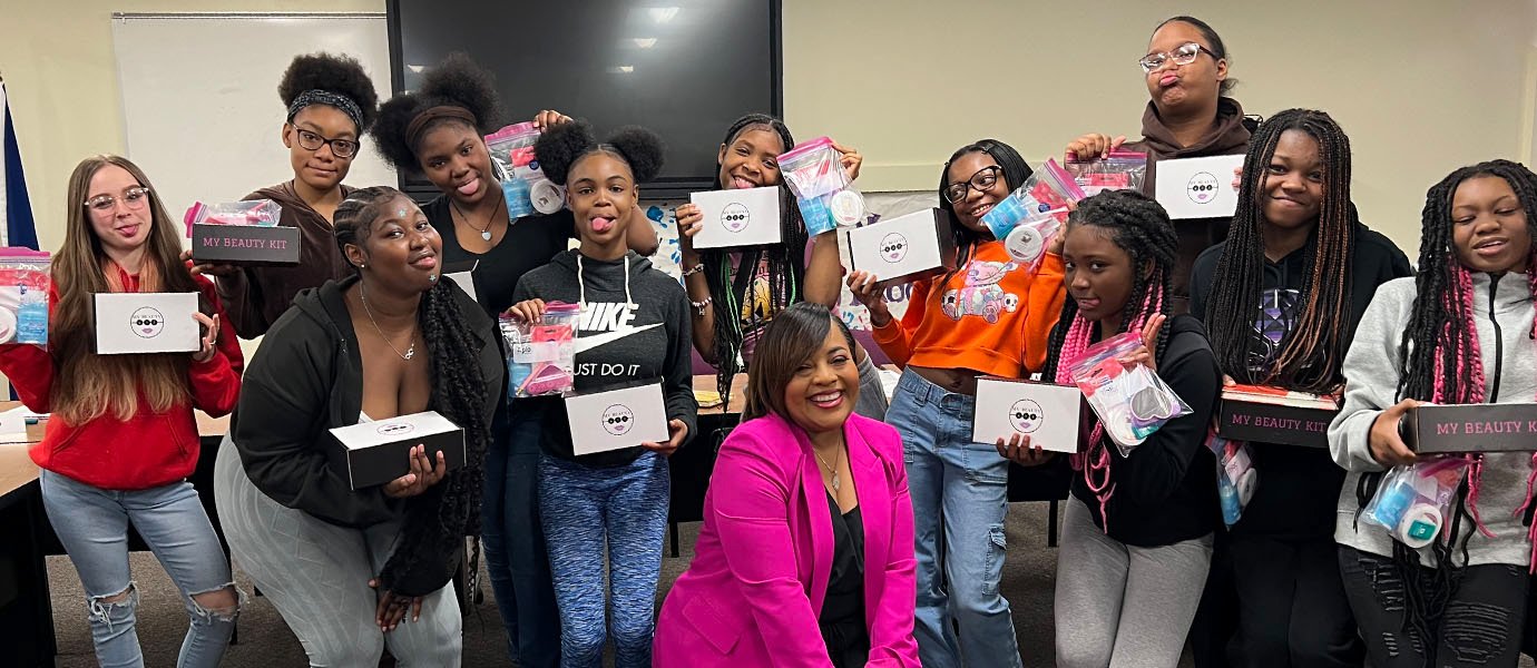 A group of people holding beauty boxes